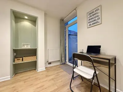 a room with a desk with a laptop on it at 2 bed house secure parking Sleeps 6 in Ipswich