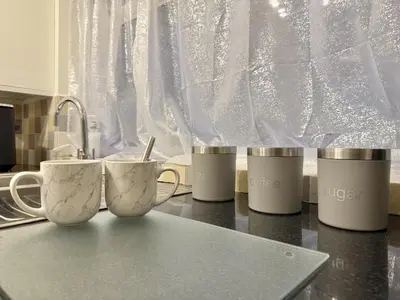 a group of coffee mugs sitting on a kitchen counter at 2 bed house secure parking Sleeps 6 in Ipswich