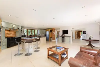 a kitchen and living room with a couch and a table at Fidlers Moat - Games Room, Gym, Hot Tub