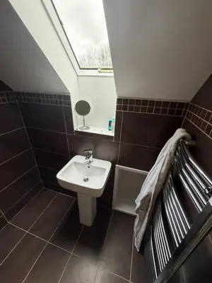 a bathroom with a sink and a skylight at Fidlers Moat - Games Room, Gym, Hot Tub