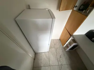 an overhead view of a white refrigerator in a kitchen at BMC Serene Spacious 1BR Flat in Enfield