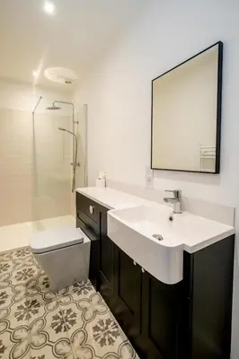 a bathroom with a sink and a toilet and a mirror at 1 Volunteer House, Leiston, near Sizewell - Ideal for a short or long term corporate lets - Managed by Aldeburgh Coastal Cottages in Leiston