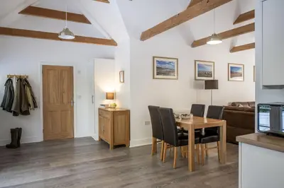 a kitchen and dining room with a table and chairs at Greenacres in Kelsale
