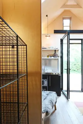 a room with a staircase and a room with a kitchen at Gazebo Lodge in Martlesham