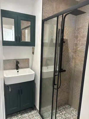 a bathroom with a sink and a shower at Lavish The White Apartment in Bury Saint Edmunds