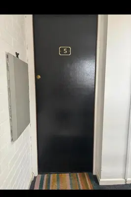 a black door with the number on it at Lavish The White Apartment in Bury Saint Edmunds