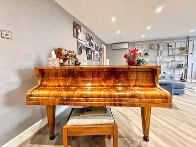 a wooden piano with stuffed animals on top of it at Charming 3 bedroom house in Chelmsford in Chelmsford