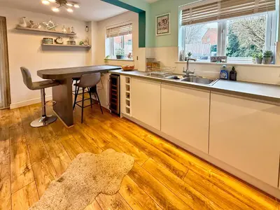 a kitchen with a table and a counter top at Charming 3 bedroom house in Chelmsford in Chelmsford