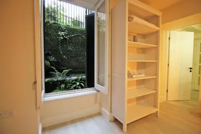a walk in closet with a large window at Central 3 BR Home with Private Courtyard in Ely