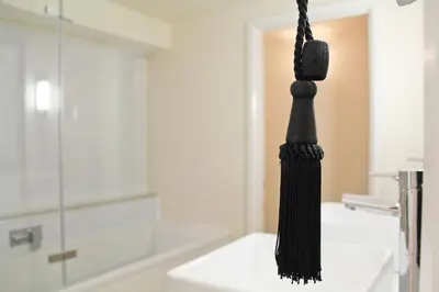 a black toothbrush hanging in a bathroom at Central 3 BR Home with Private Courtyard in Ely