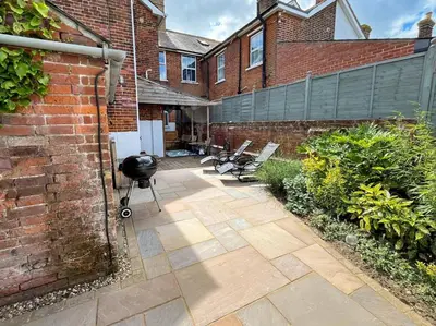 a patio with benches in front of a brick building at 3 Bed in Felixstowe oc-s27808 in Felixstowe