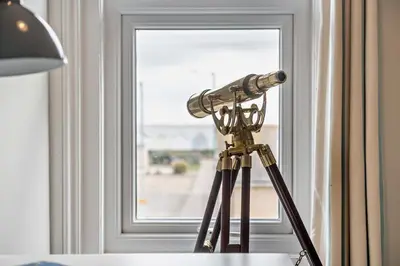a telescope sitting on a table next to a window at 3 Bed in Felixstowe oc-s27808 in Felixstowe