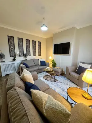 a living room with a couch and a tv at The Opulent Property Project Southend 4 Bed Sleeps 7 in Southend-on-Sea