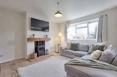 a living room with a couch and a fireplace at The Opulent Property Project Colchester 3BR nr Station Sleeps 6 Fastwifi Free Parking in Lexden