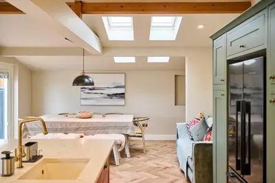 a kitchen and living room with a table and a dining room at Host & Stay The Coral Cottage in Wymondham