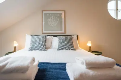 a bedroom with a large white bed with two pillows at Luxury Leiston 2 bed 2 bath with parking in Leiston