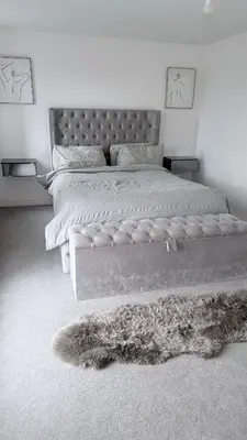 a bedroom with a large bed and a furry rug at Private Kingsize Bedroom in Horndon on the Hill