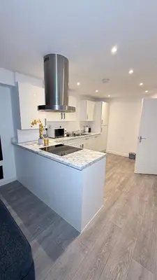 a white kitchen with a counter top in a room at Private Kingsize Bedroom in Horndon on the Hill