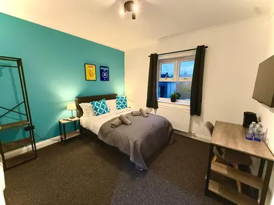 a bedroom with a bed and a window at Sleep Hub in Leiston