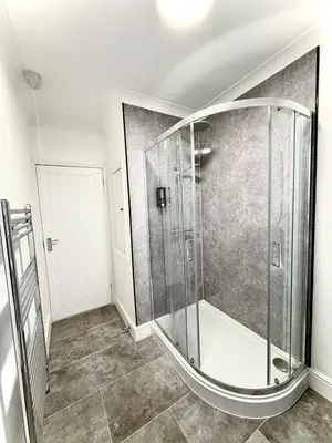 a bathroom with a glass shower in a room at Sleep Hub in Leiston