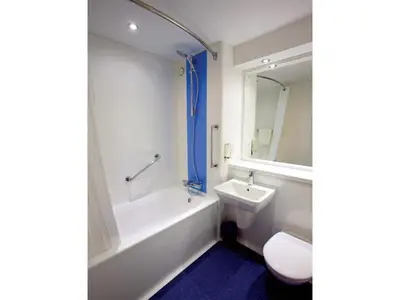 a bathroom with a tub and a sink and a toilet at Travelodge Ipswich Capel St Mary in Capel Saint Mary