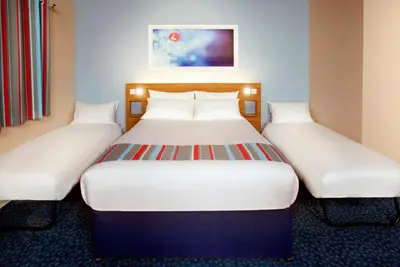 a pair of beds in a hotel room at Travelodge Huntingdon Fenstanton in Fenstanton