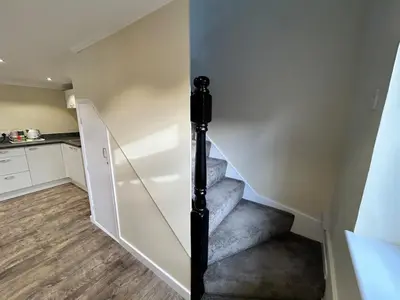 a staircase in a house with a stair case at The old greengrocers Battlesbridge in Rawreth