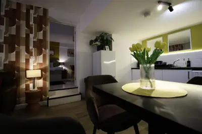 a dining room with a table with flowers in a vase at Central Location Stylish 1-Bed Apartment Free Parking in Colchester