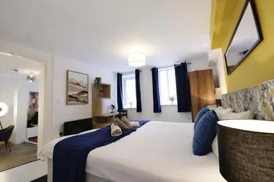 a bedroom with a large white bed in a room at Central Location Stylish 1-Bed Apartment Free Parking in Colchester