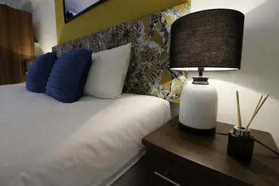 a bed with two pillows and a lamp on a night stand at Central Location Stylish 1-Bed Apartment Free Parking in Colchester