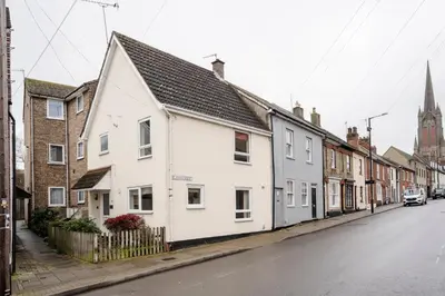 a street with white houses and a church at La Casa Bianca in Bury Saint Edmunds