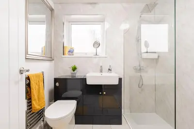 a bathroom with a toilet and a sink and a shower at La Casa Bianca in Bury Saint Edmunds