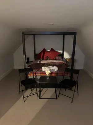 a bedroom with a large bed with red pillows at 7 The Quay in St Ives