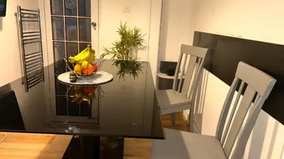 a table with a bowl of fruit on top of it at Serene Guest Retreat in Basildon Comfort and Convenience Await in Basildon