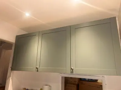 a green cabinet in a room with boxes at Serene Guest Room Retreat in Basildon with Private Entrance in Basildon