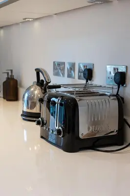 a toaster sitting on a counter with a tea pot at Station View - Modern Flat Near Centre & Station in Cambridge