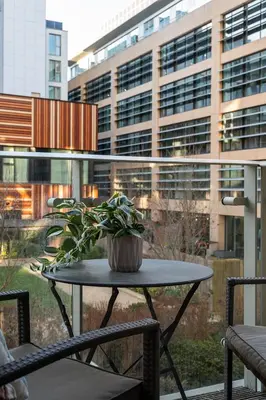 a potted plant sitting on a table in front of a building at Station View - Modern Flat Near Centre & Station in Cambridge
