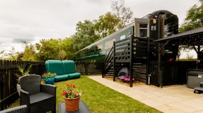 an rv is parked in a yard with a fence at The Carriage Ely in Coveney