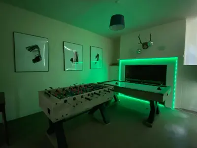 a room with a pool table and a green light at Finest Retreats - Clavering Hall in Saffron Walden