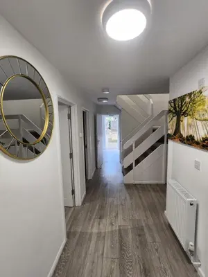 a hallway with a large mirror on a wall at Ensuite premier rooms in Basildon