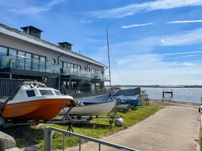 a boat is parked in front of a building at Admiralty Lodge in Shotley Gate