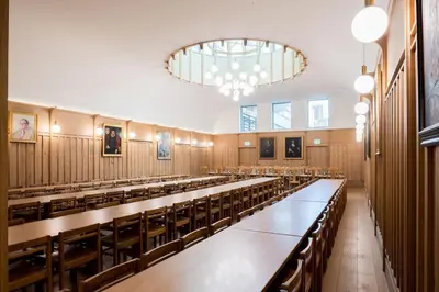 a large room with rows of tables and chairs at St Catharine's College, Cambridge in Cambridge