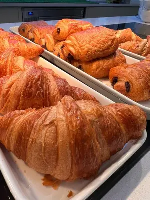 a bunch of croissants on trays in a bakery at St Catharine's College, Cambridge in Cambridge