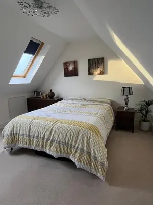 a bedroom with a bed in a attic at Modern Suite with a Queen Bed, Ensuite & Workspace in Chelmsford
