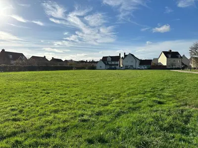 a large field of green grass with houses in the background at Modern Suite with a Queen Bed, Ensuite & Workspace in Chelmsford