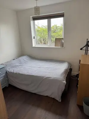 a bedroom with a bed and a window at House in Colchester with parking in Colchester