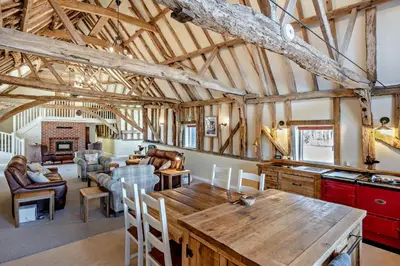 a kitchen and living room with a wooden table at 6 Bed in Ardleigh oc-b35089 in Ardleigh