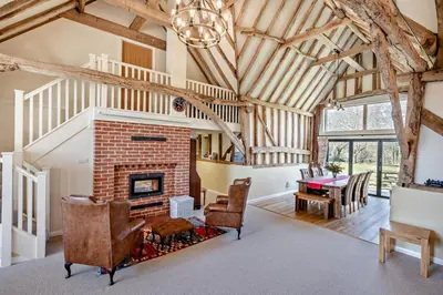 a living room with a brick fireplace and a table at 6 Bed in Ardleigh oc-b35089 in Ardleigh