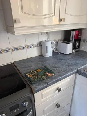 a kitchen counter with a stove and a microwave at The Wright One Bedroom Place To Stay in Kingsgate