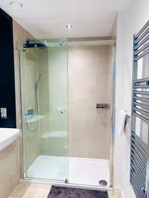 a shower with a glass door in a bathroom at Bright Corner Apartment by Cambridge Station with Free Allocated Underground Parking & Flexible Beds in Cambridge